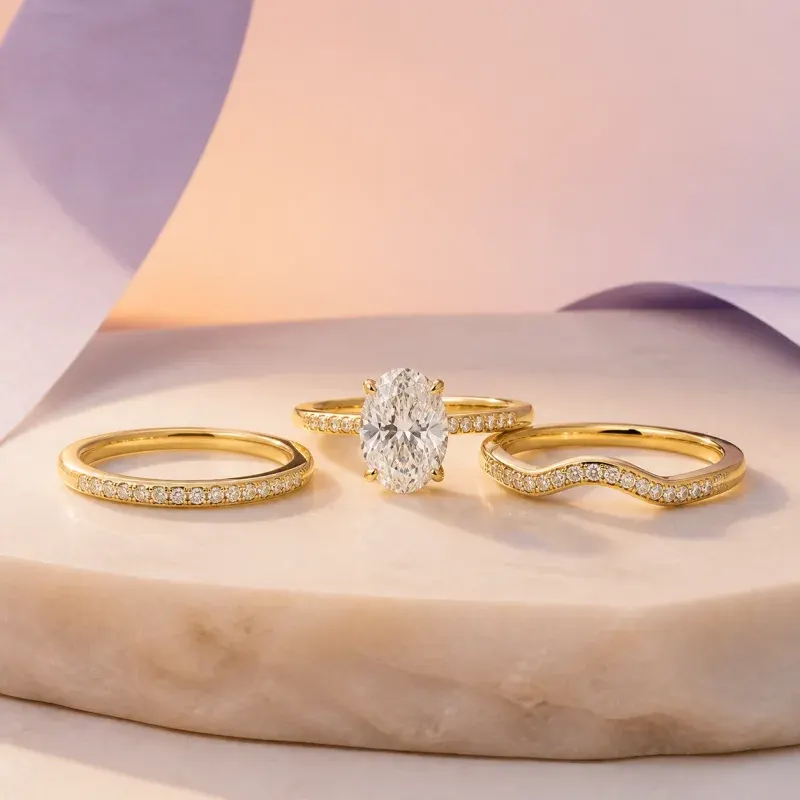 Oval solitaire with matching yellow-gold wedding bands